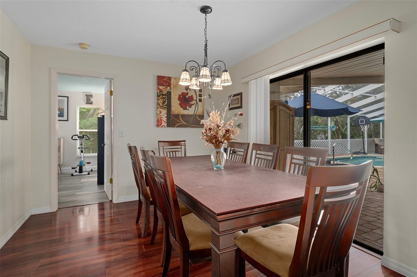 Dining room off kitchen and access to the pool.