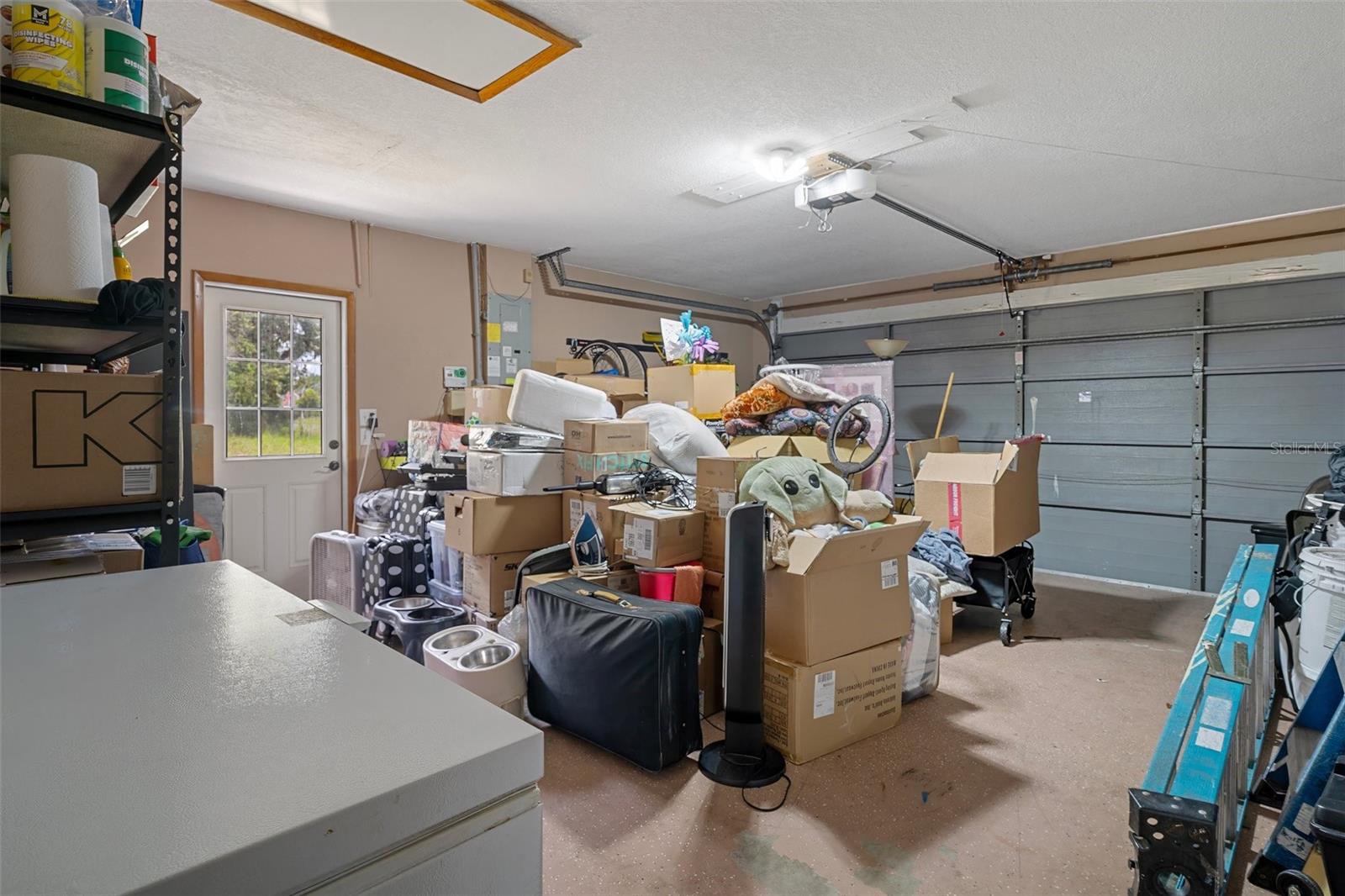 Garage with door opener and side entrance door.
