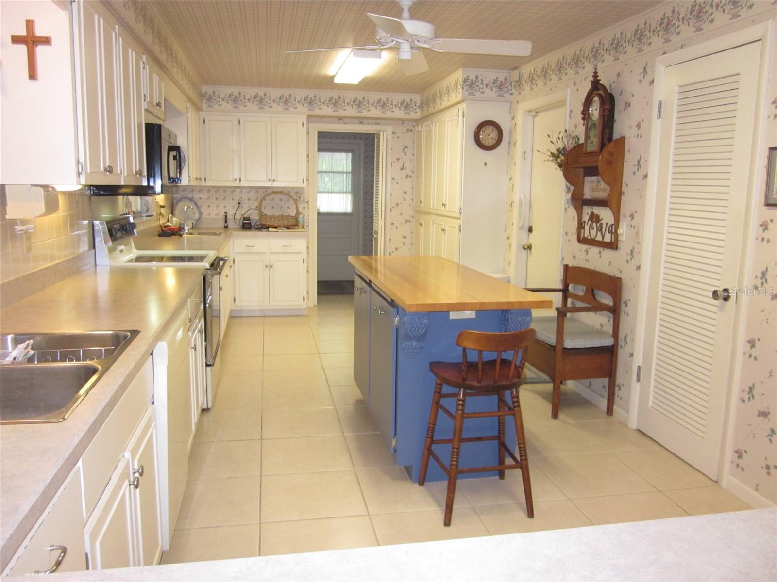 Alt. view of the kitchen. Ample cabinet storage & food prep areas.