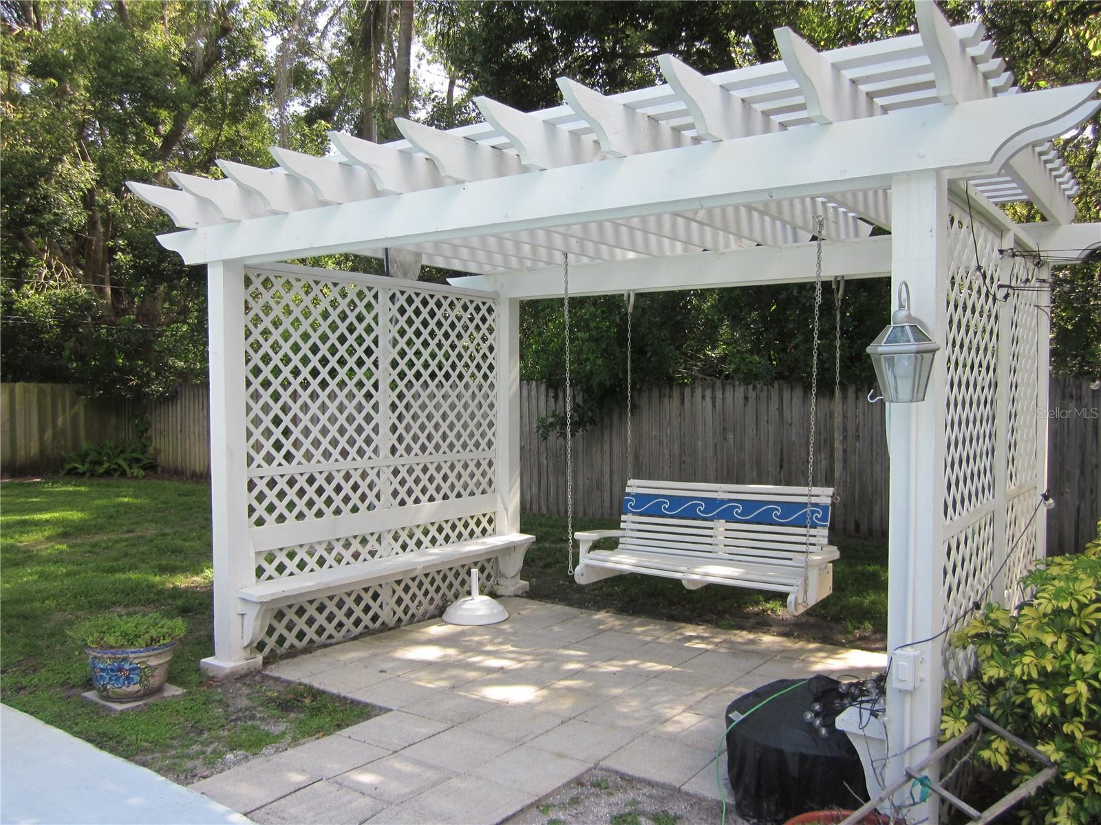 Attractive pool side pergola with porch swing