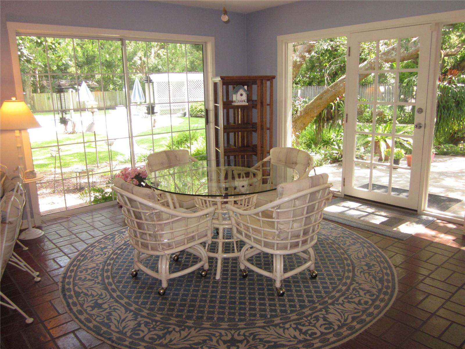 Enclosed back patio with gorgeous views of relaxing & private back yard.