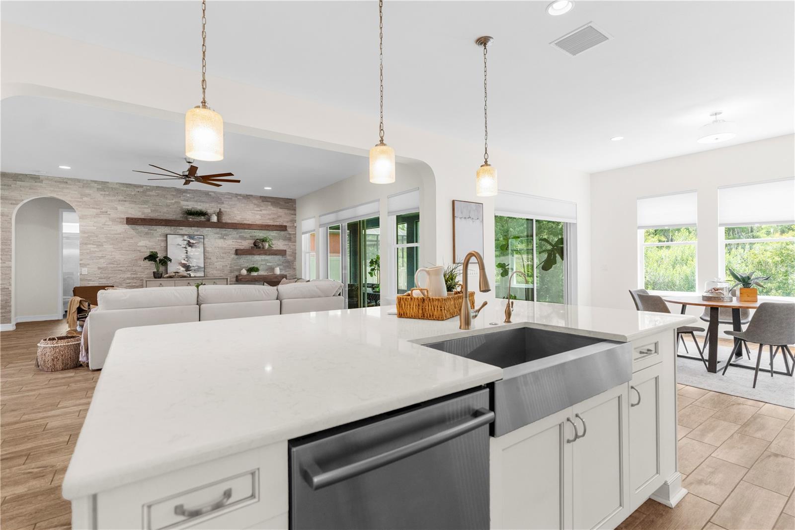 Kitchen with view to informal dining room, and family room