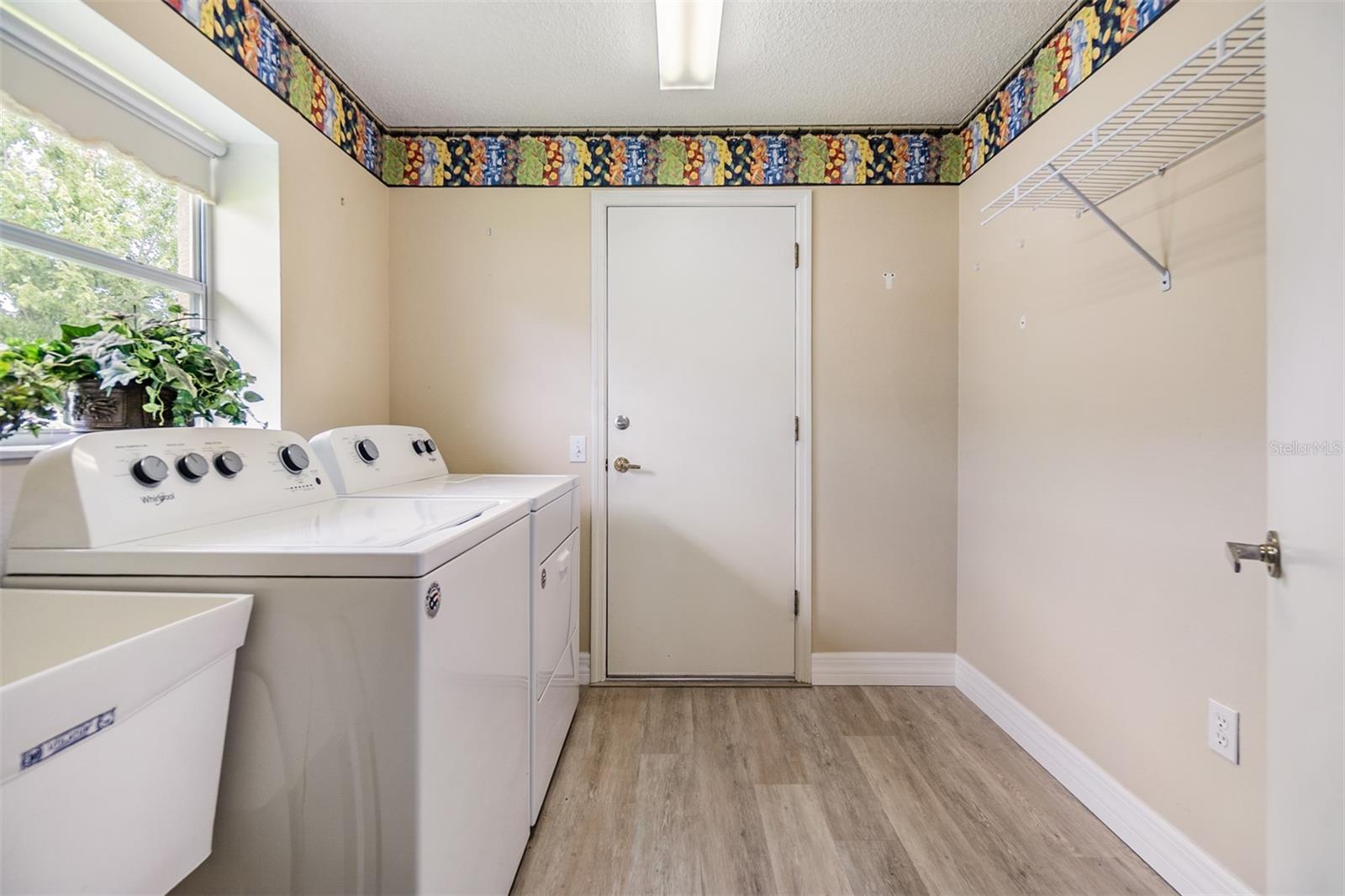 Walk in laundry room with utility sink