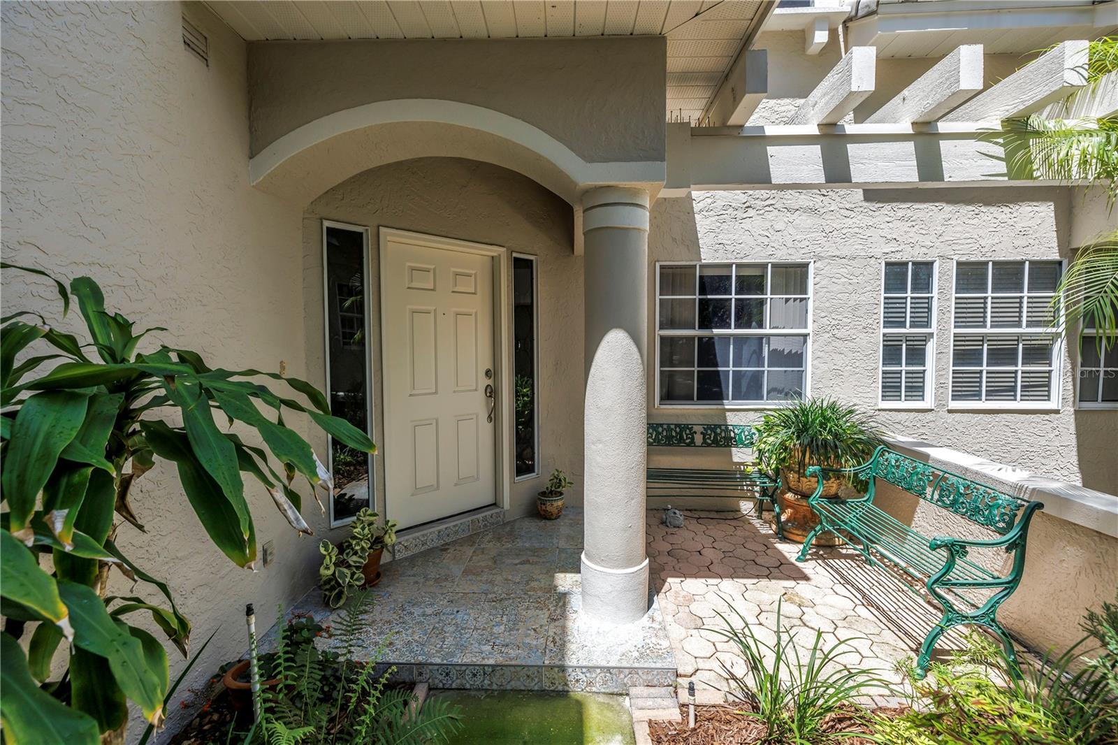 Attractive entry with mature garden and sophisticated tile porch