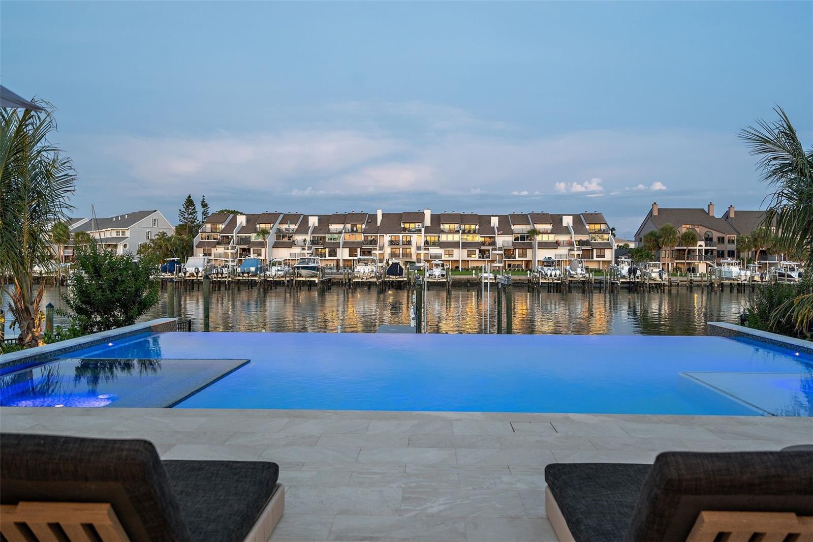 Infinity pool with canal backdrop