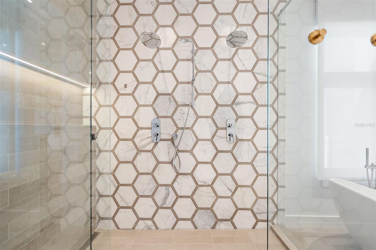 The primary shower is a work of art in Calacatta and Volpe.
