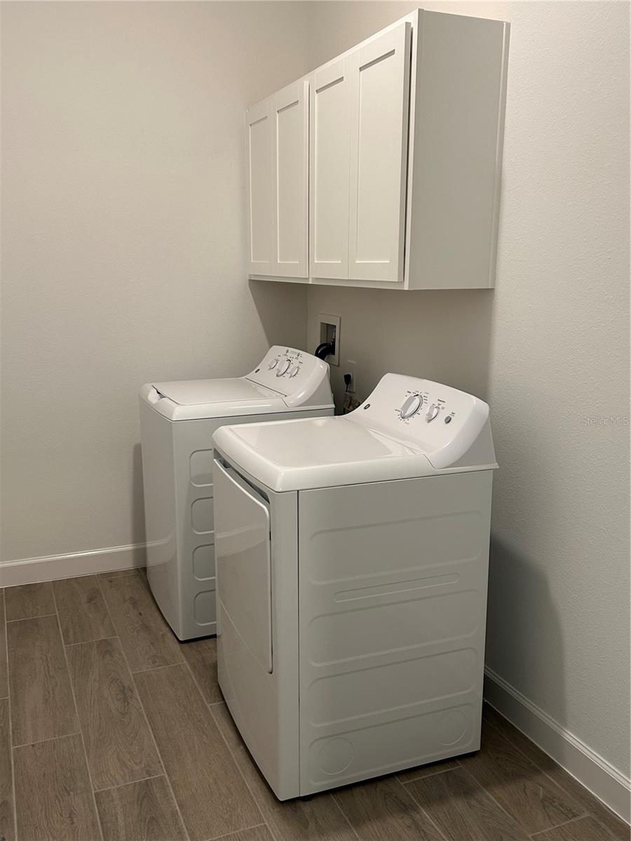 Laundry Room w/ Washer/Dryer and Cabinets in Laundry Room