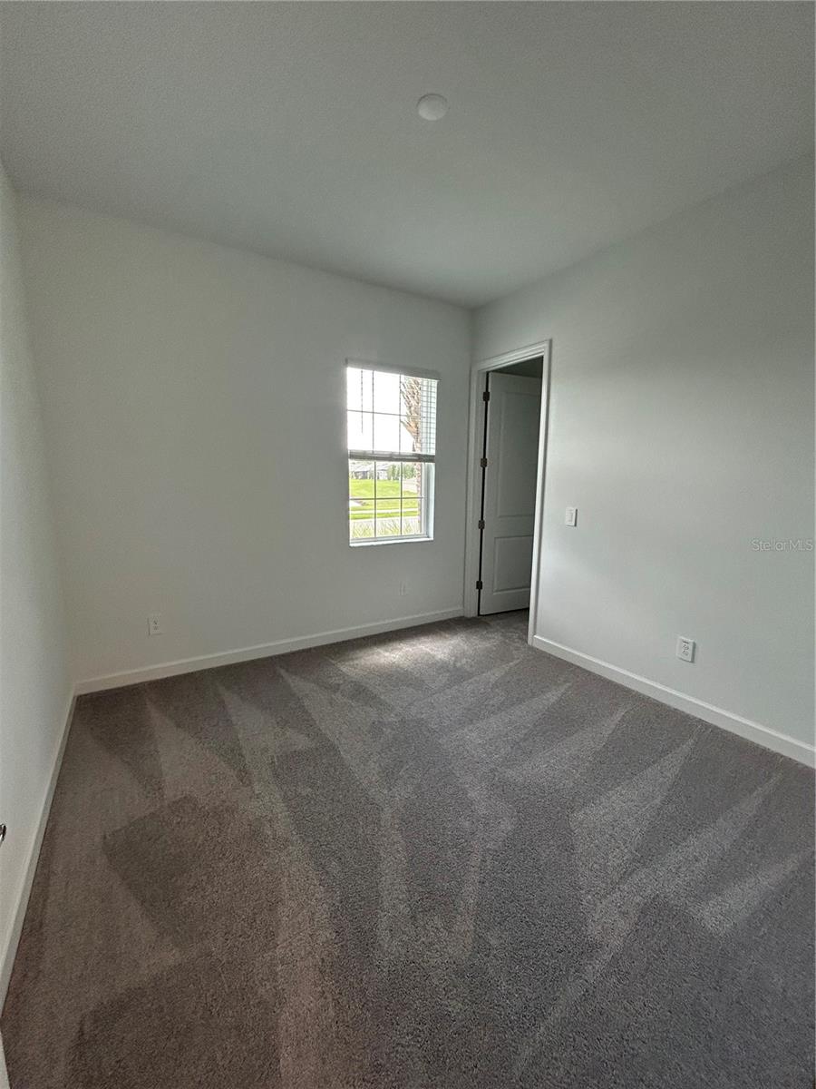 2nd Bedroom (split plan)with 2nd half bathroom directly across the hallway