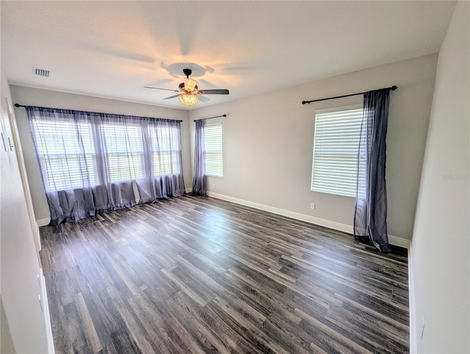 Primary Bedroom with an en suite bathroom, walk-in closet, and dual sinks.