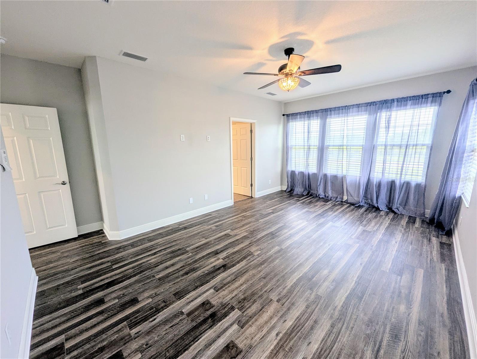 Primary Bedroom with an en suite bathroom, walk-in closet, and dual sinks.