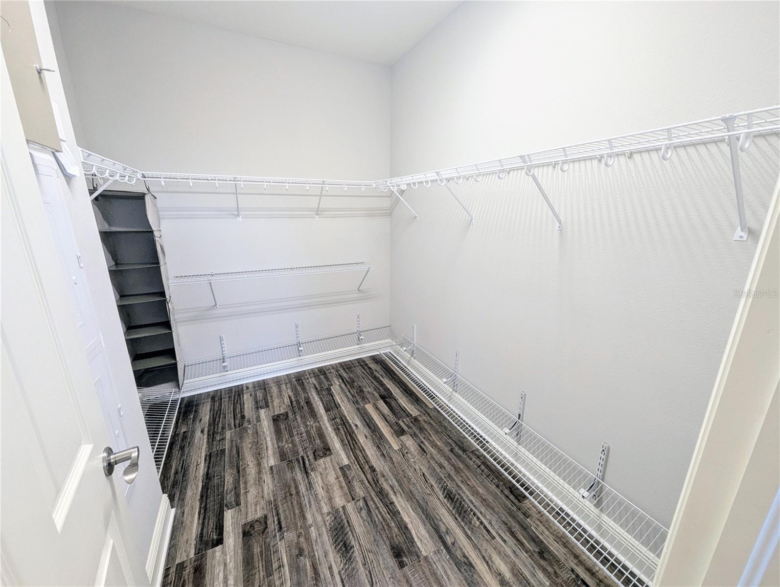 Primary Bedroom with an en suite bathroom, walk-in closet, and dual sinks.