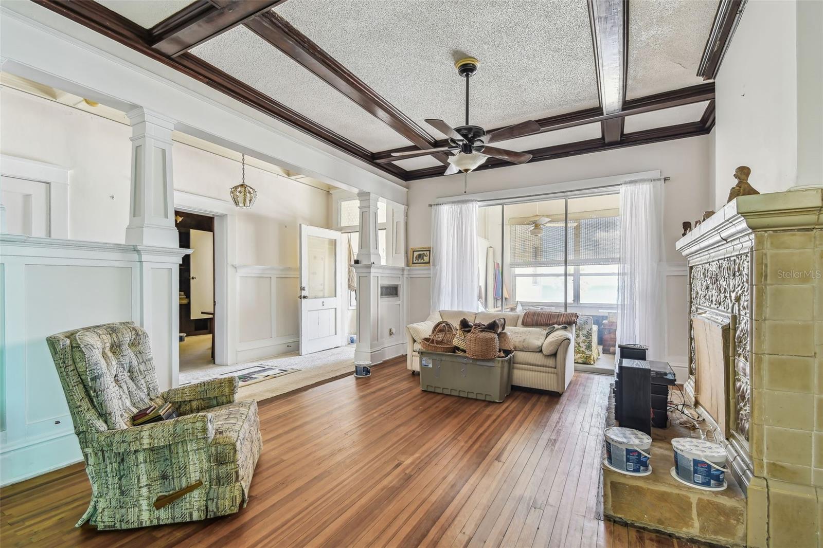 Living Room w/fireplace & sliders to the enclosed patio
