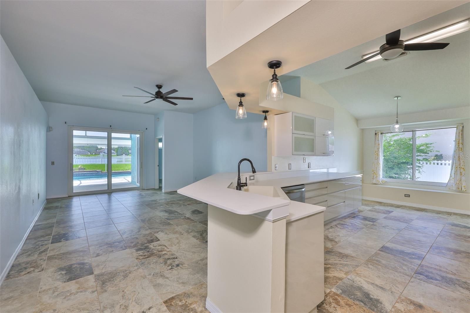 Great room, wrap around breakfast bar, pendant lighting, all new cabinets