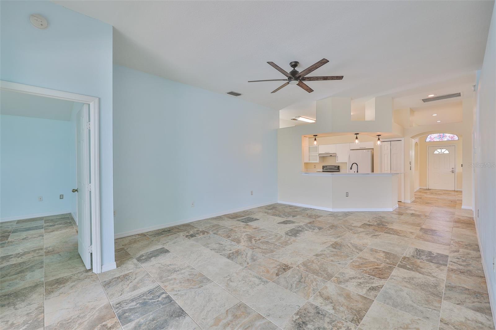 Great Room, Primary Bedroom on left, looking to Breakfast Bar, kitchen and foyer