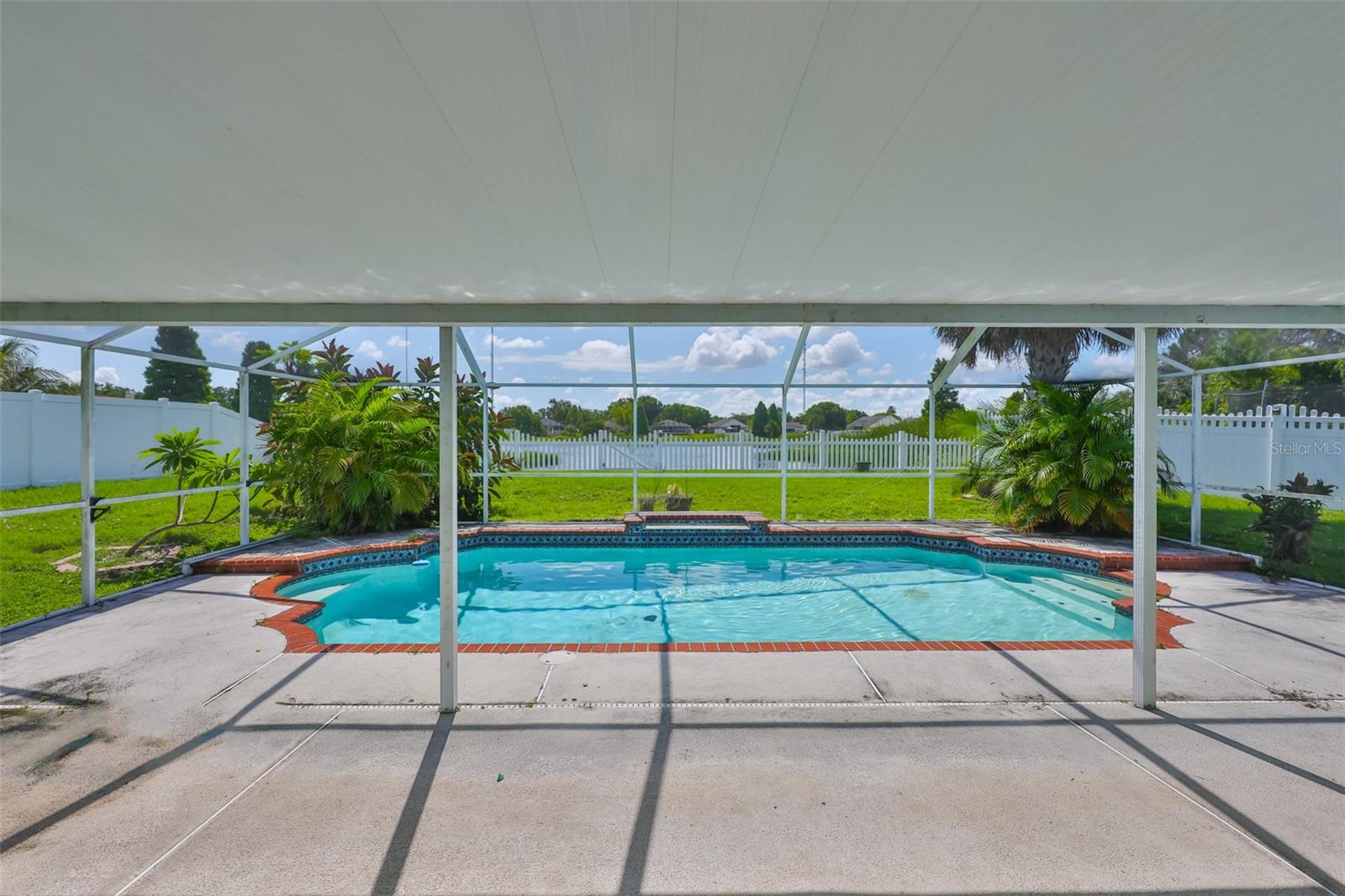 Your very own private pool with waterfall. Partly roofed, partly screened to keep the rain off! Make this your very own tropical garden! Pond behind fence straight ahead.