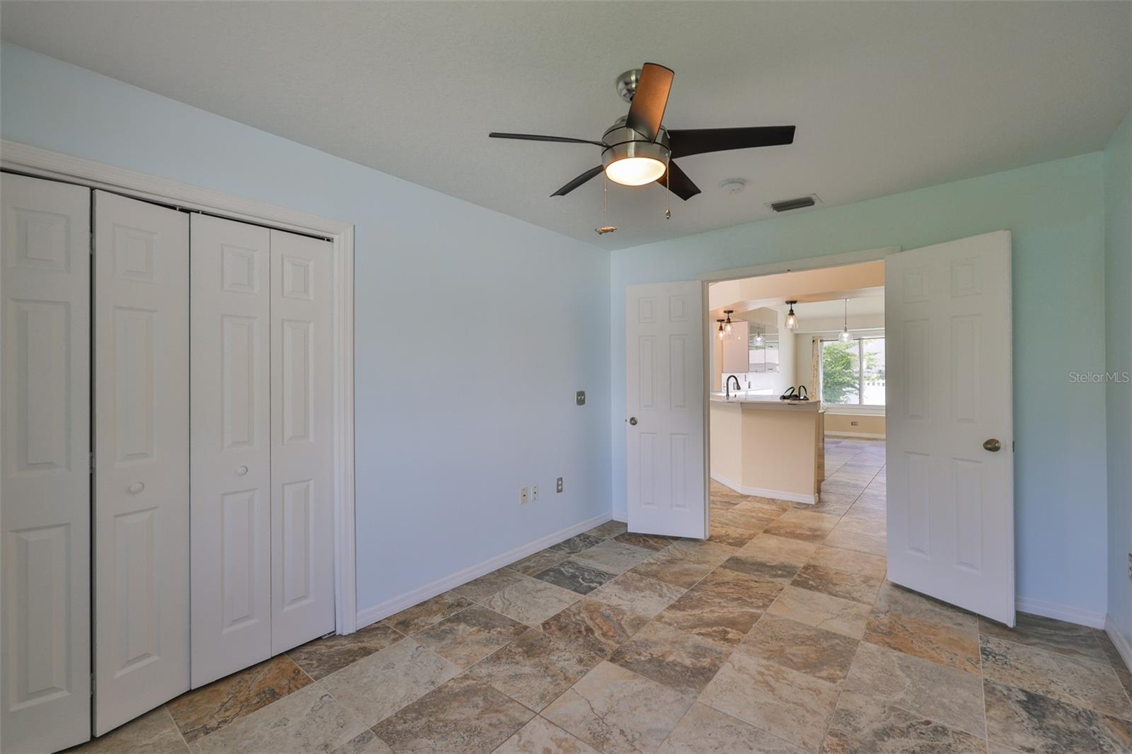 Bedroom 4; can easily be an office, playroom or media room with the French Doors, looking to kitchen, breakfast bar and dinette