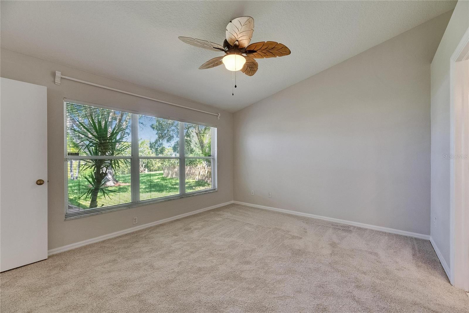 Primary Bedroom with large window overlooking backyard