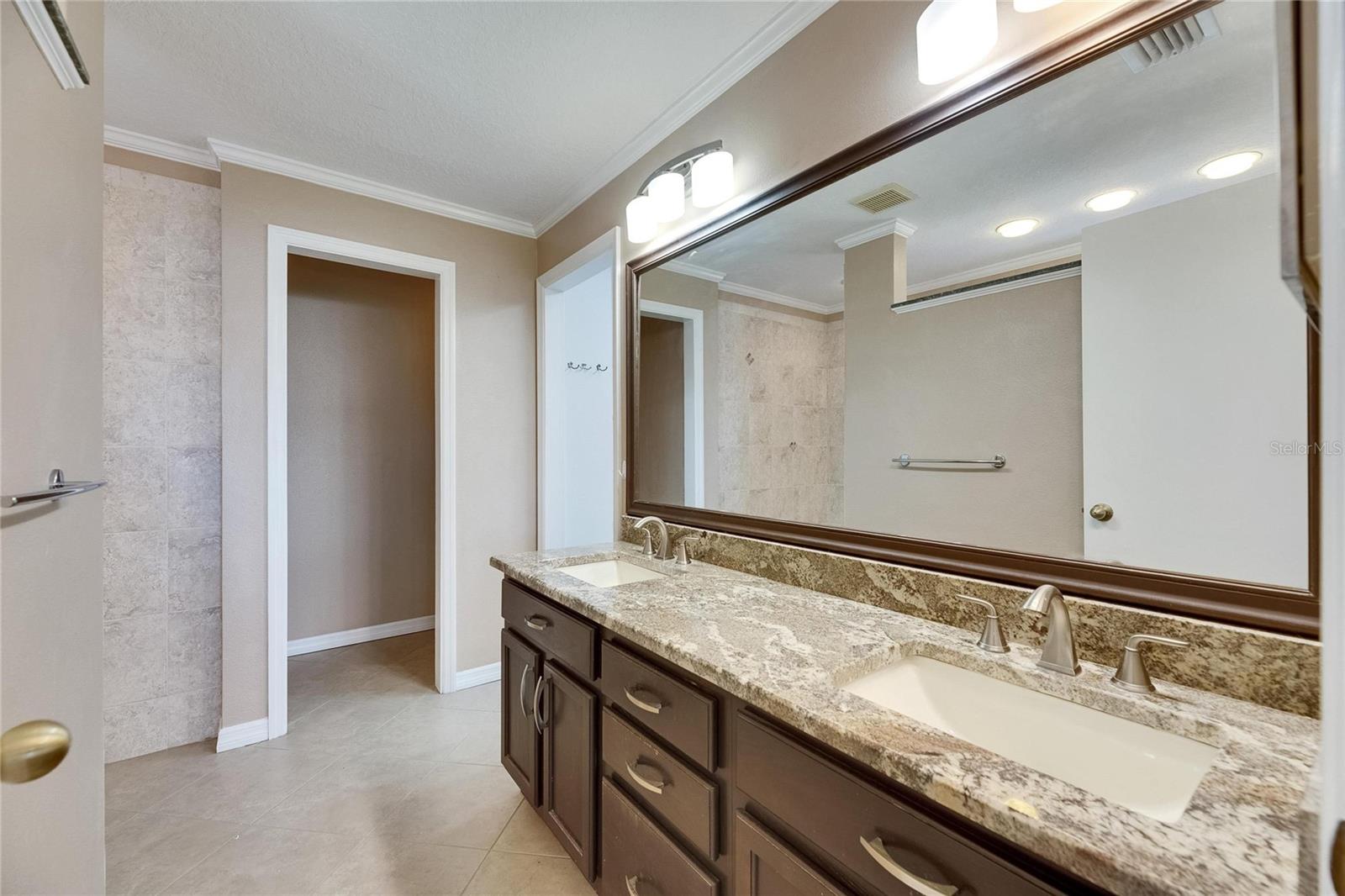 En-suite bath with double sink vanity and water closet