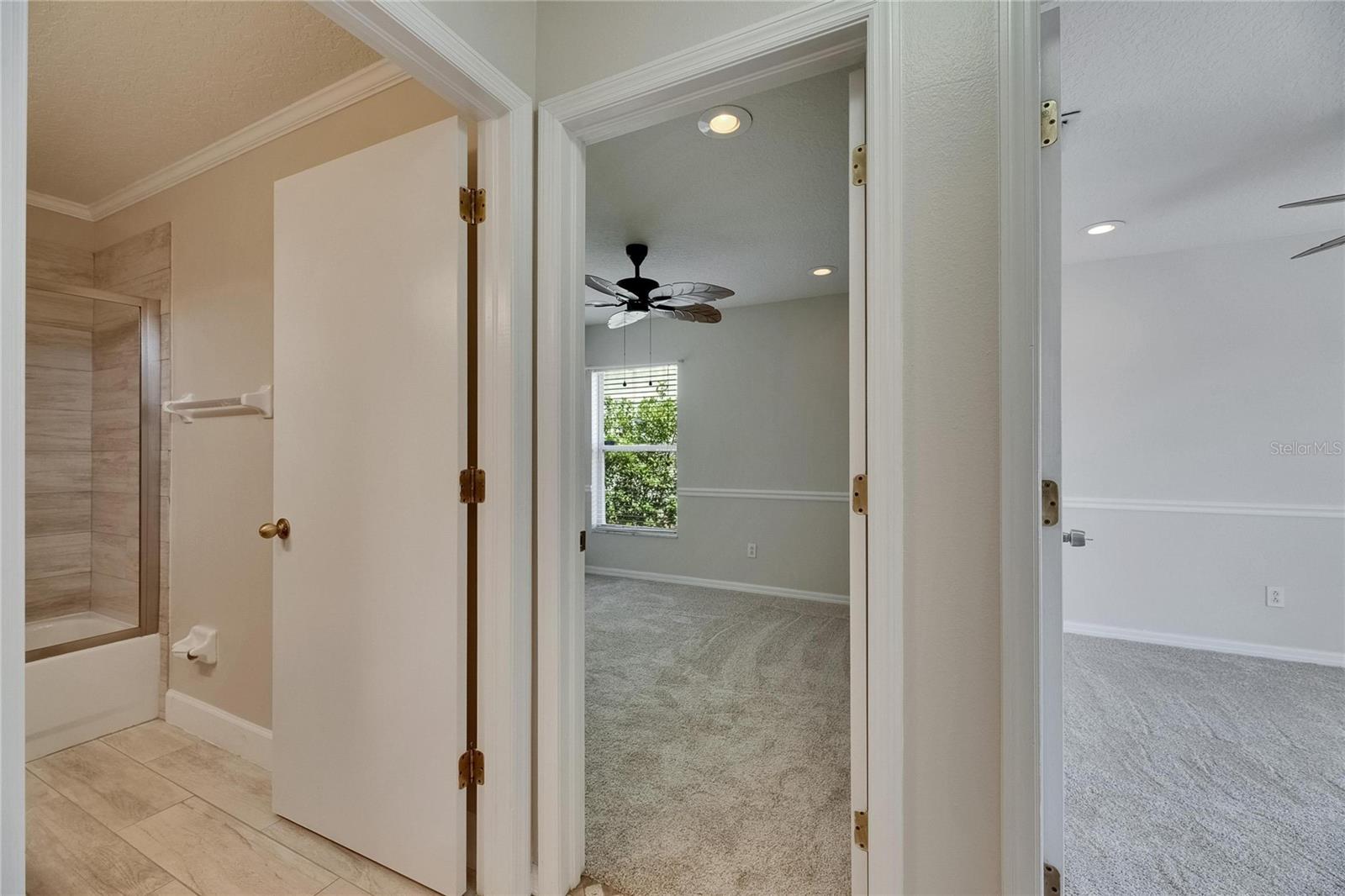 Hall at entryway with secondary bedrooms and bath