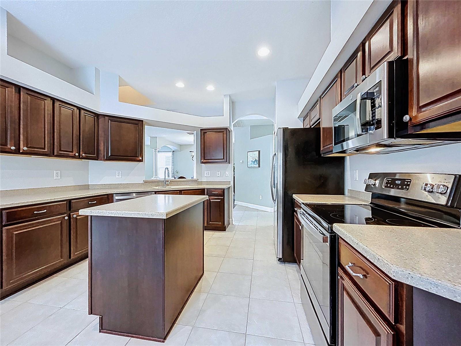 Kitchen with island with Corian countertops