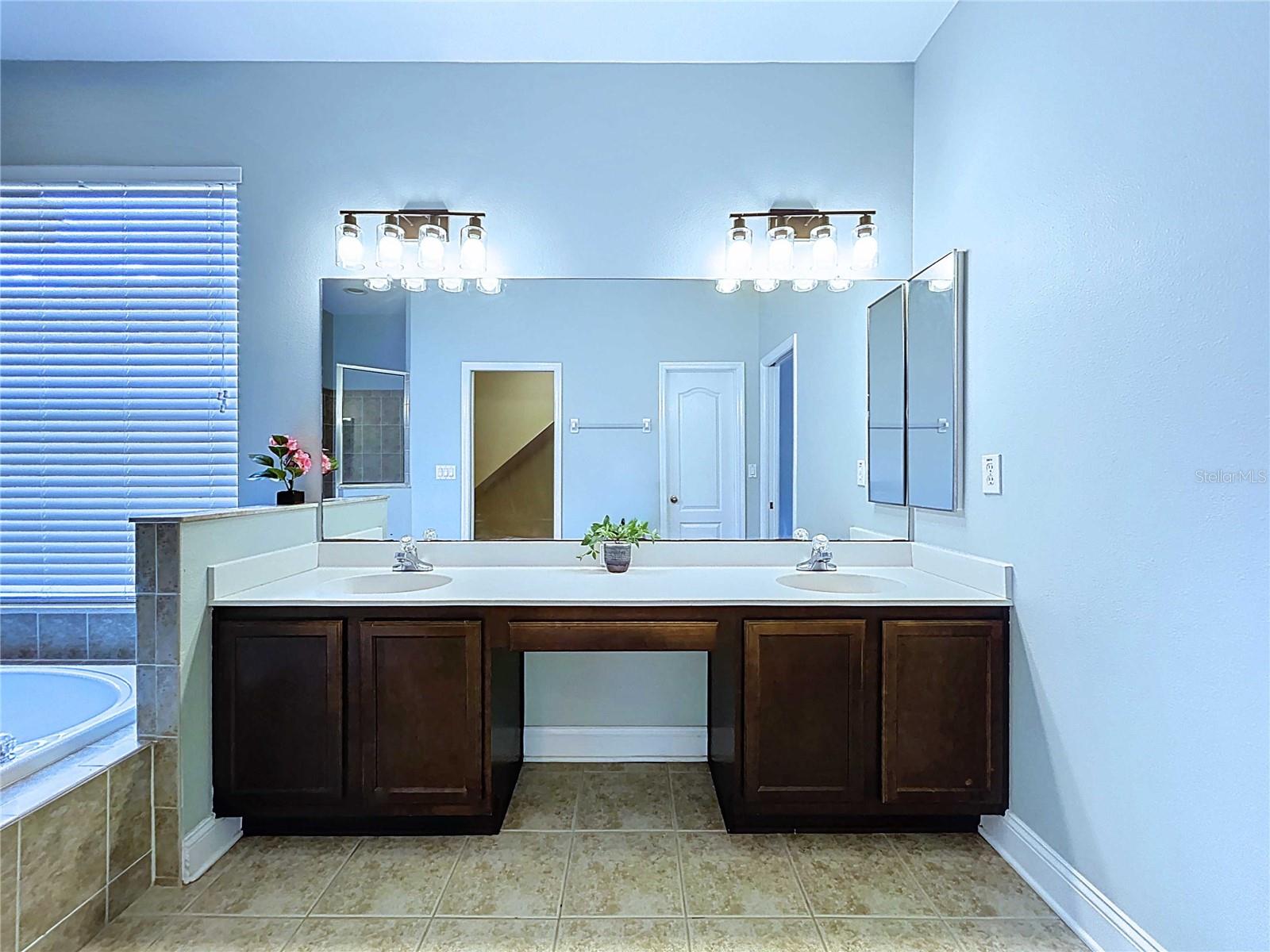 Primary bathroom featuring double vanities
