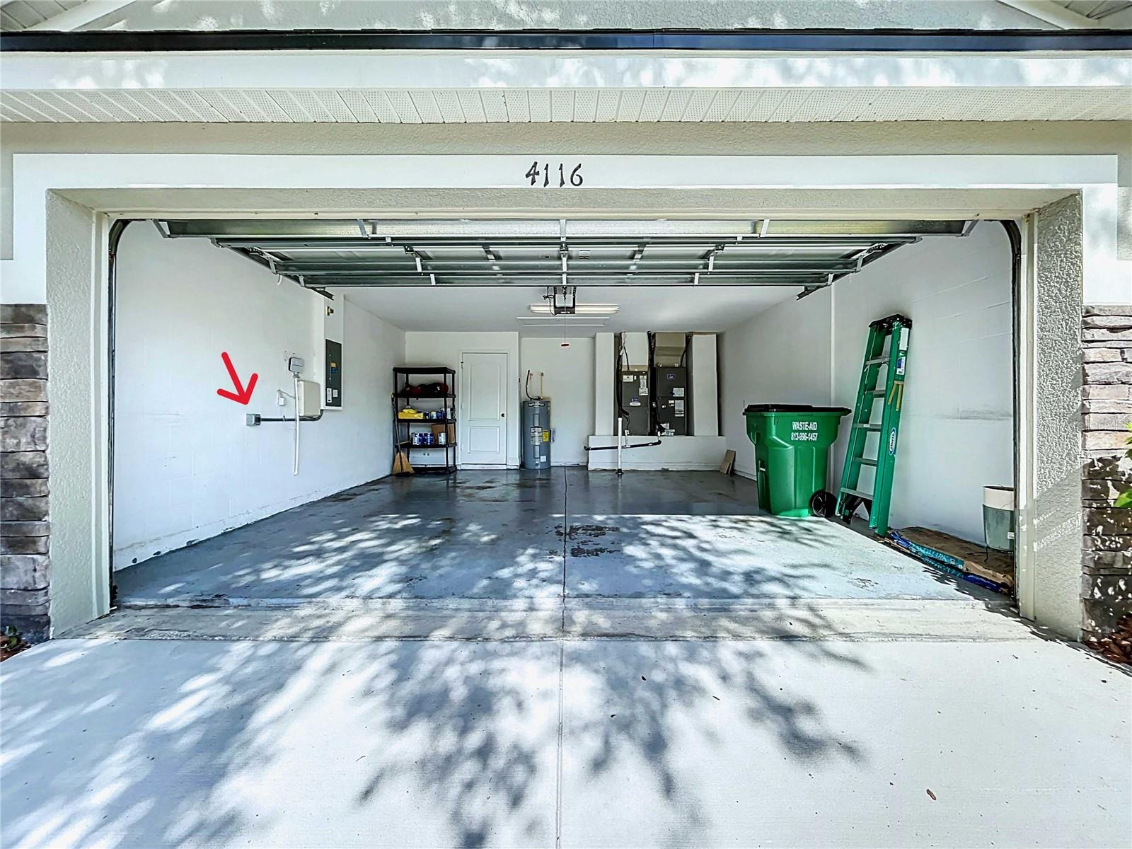 Garage with epoxy floor and EV charger on wall