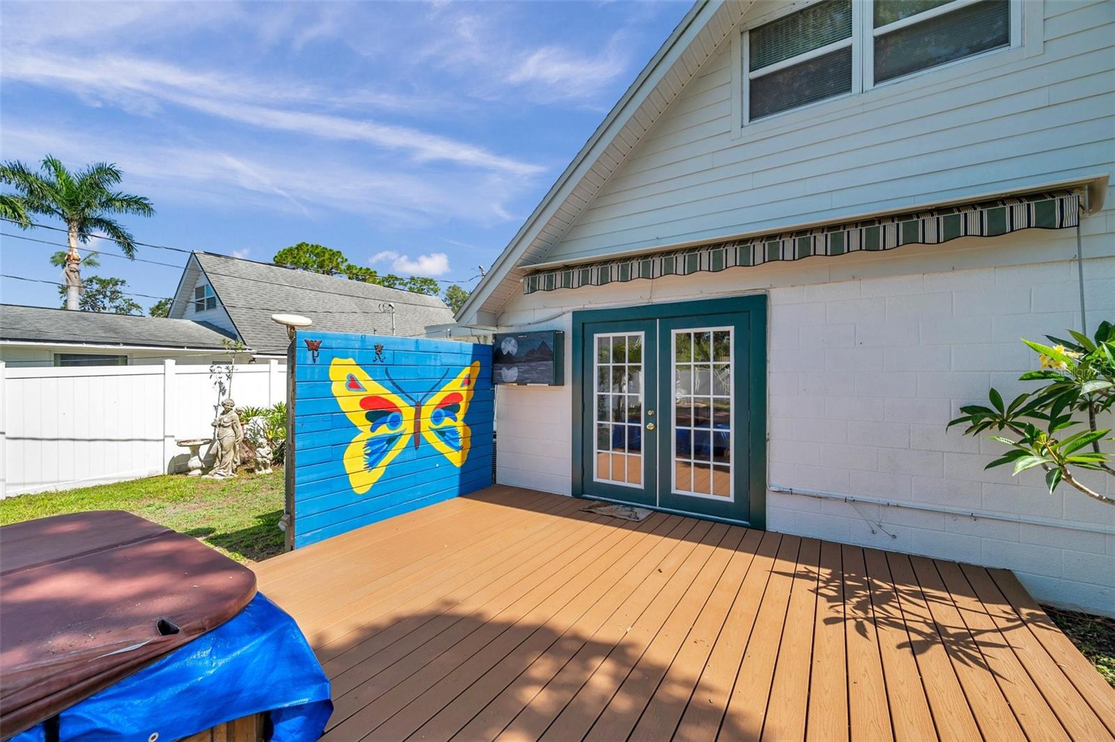 Double French doors out to the backyard.  Note the sunscreen above the doors that is easy rolled open for shade on the deck.