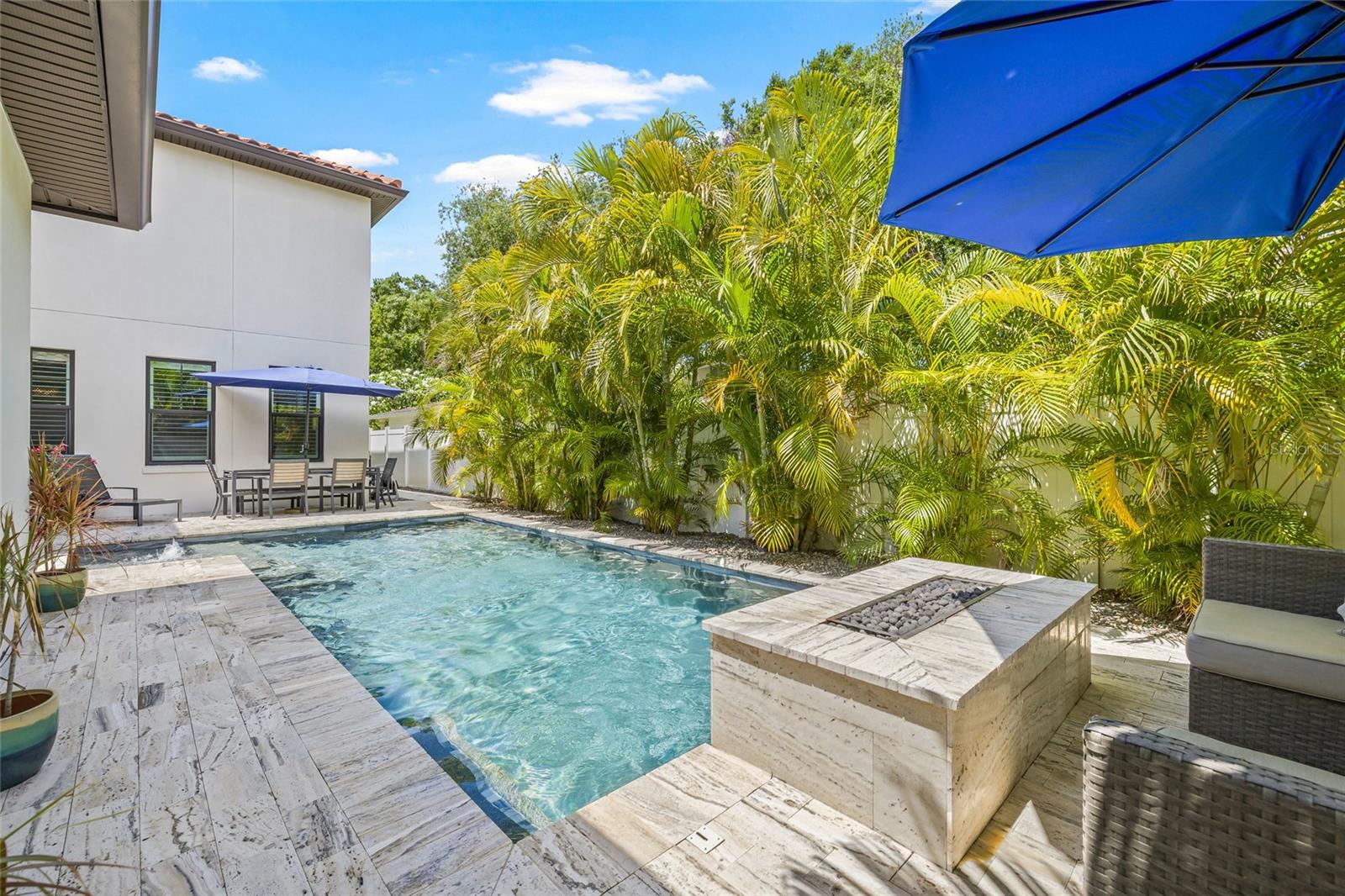 Surrounded by gorgeous Travertine pavers, plenty of space for shade and sun.
