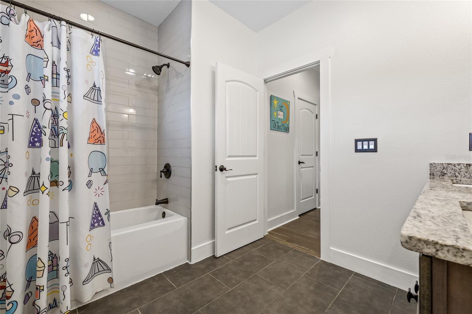 Large shared full bath with a tub in the upstairs hall.