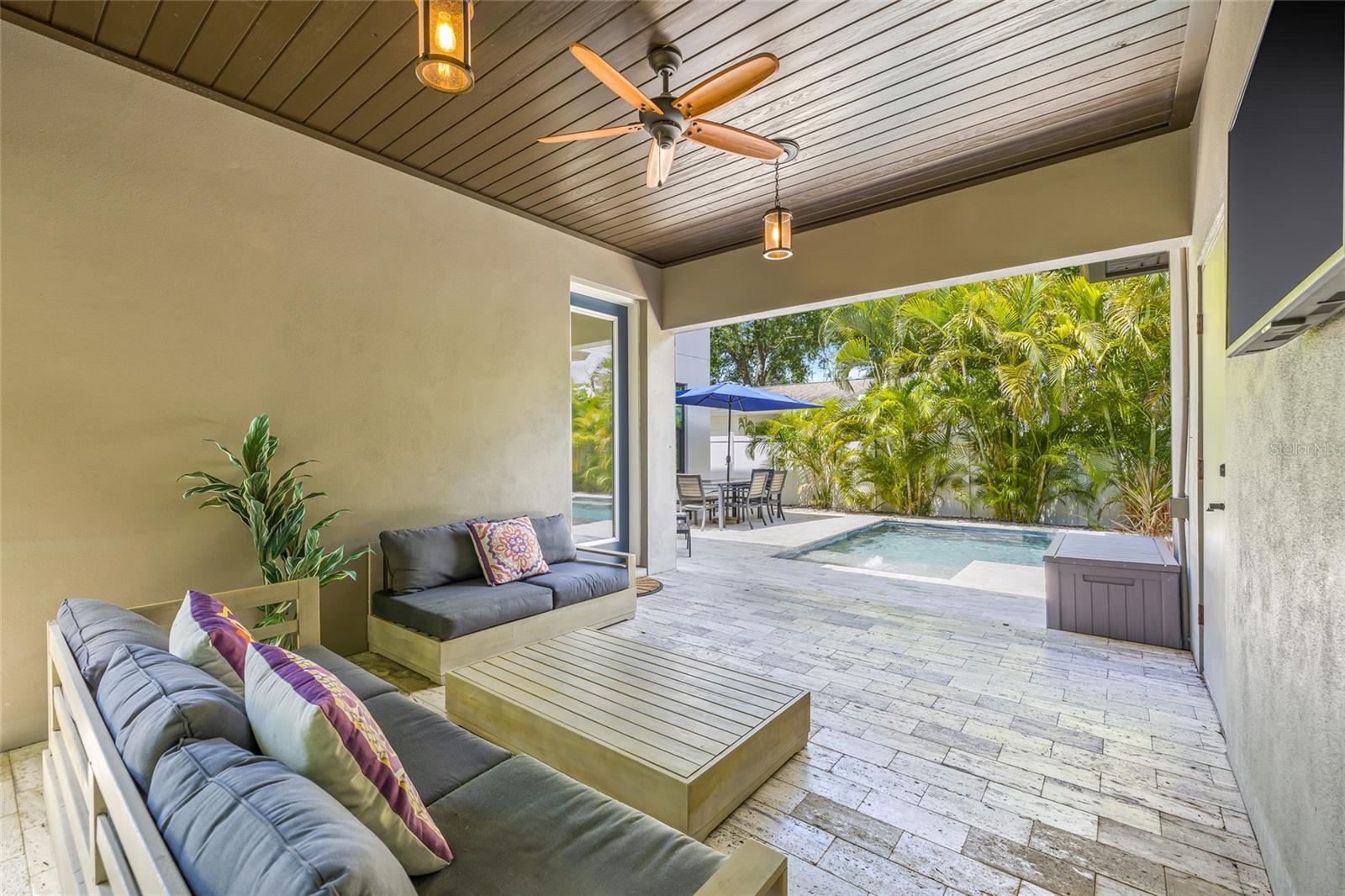 The beautifully appointed breezeway serves as covered entertainment space outside.