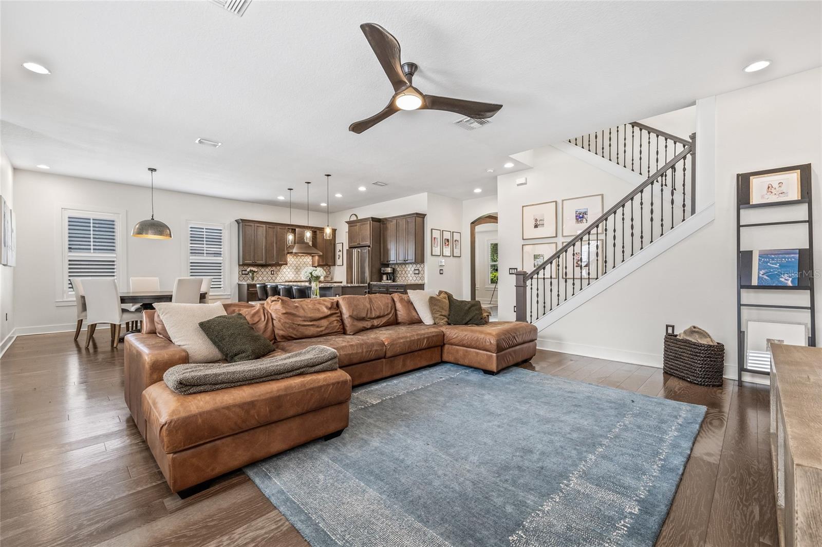The open staircase with iron bannister provides an airy ambiance.