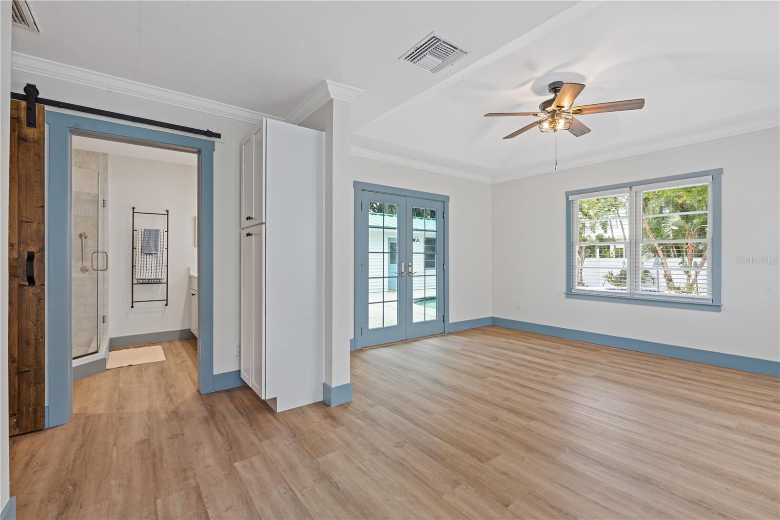 Primary Bedroom with Private Bathroom.  French doors which gives you your private access to the outside pool oasis.