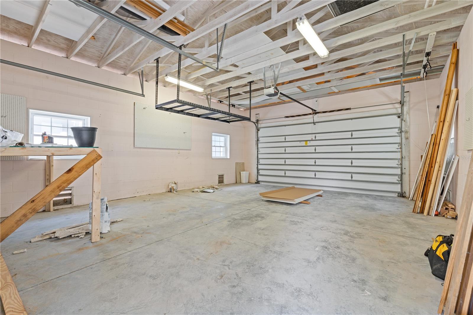 Plenty of parking space and overhead storage in the oversized 2 car garage.  2 separate doors (front 2 car opener and another rear door)