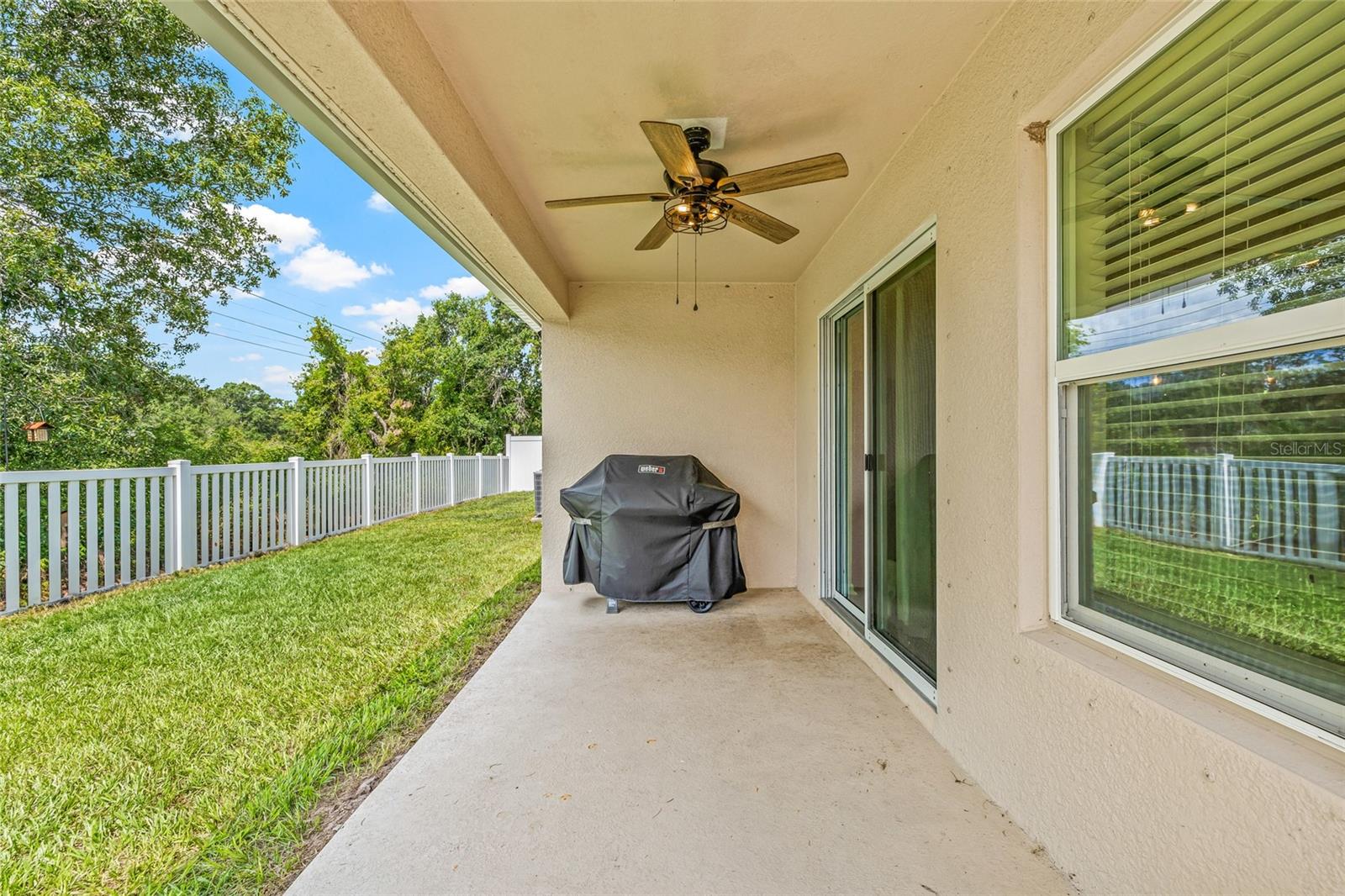 Outdoor covered patio with ceiling fan