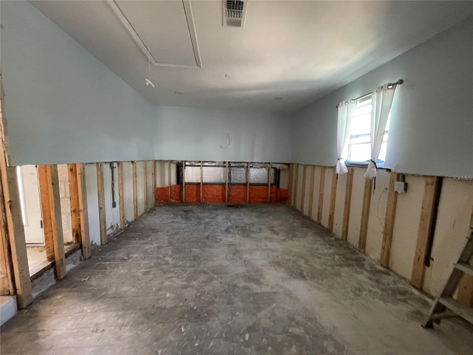 Garage area that has been converted into living space.
