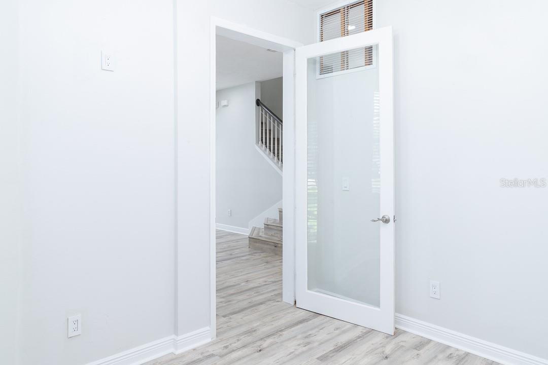 First floor flex space. Office, Den, Dining Room with a custom one lite door.