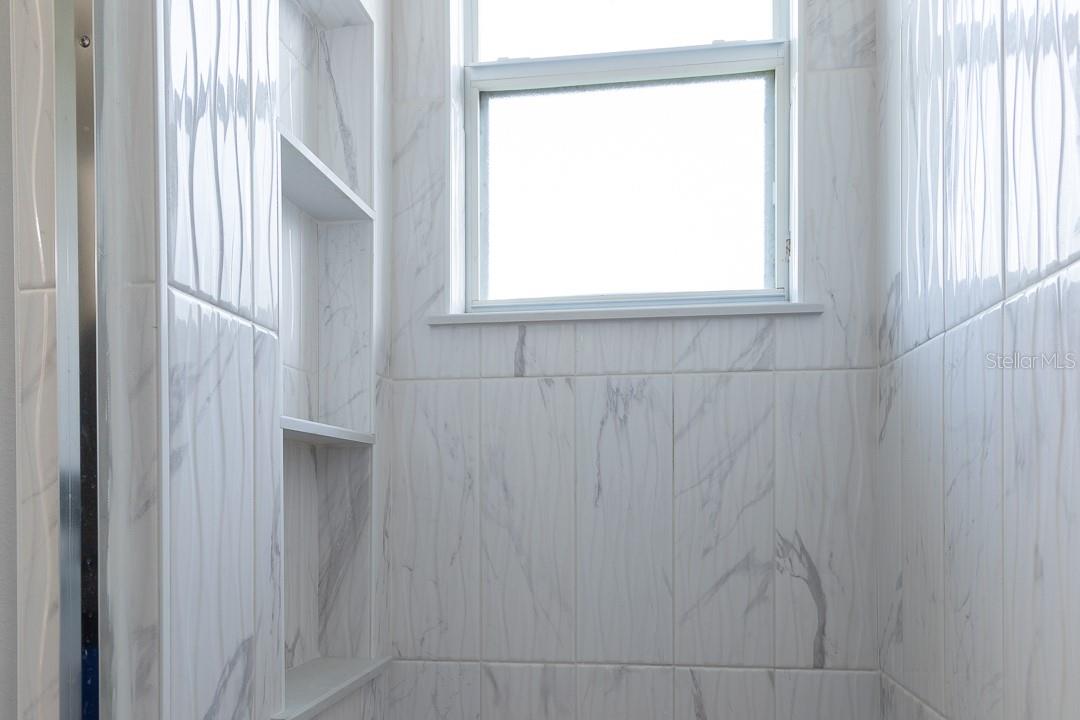 Custom shower with 3 tier built-in shelves