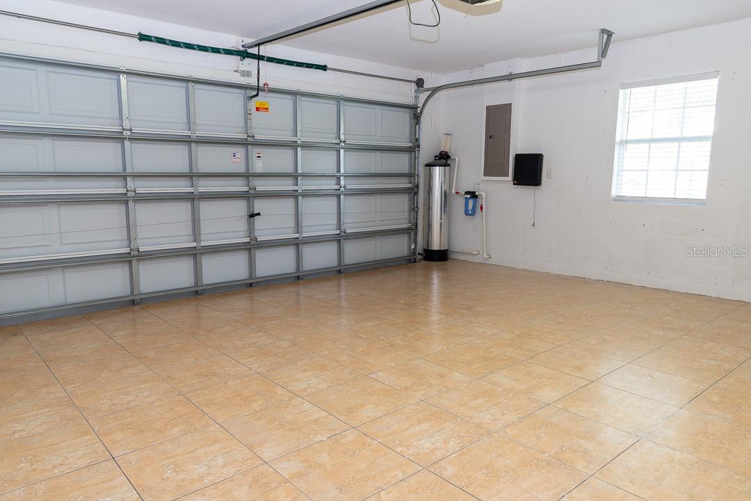 Water filtration system with two (2) washable filters near garage door