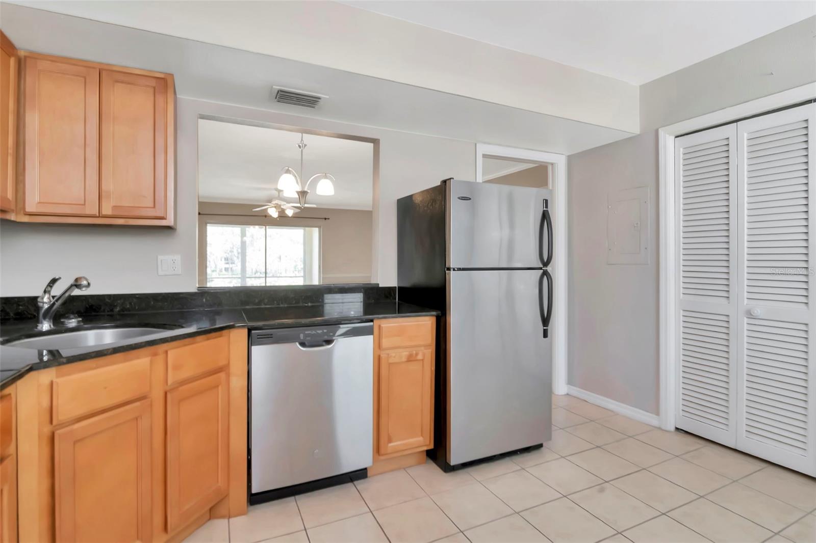 Stainless steel appliances and open to kitchen
