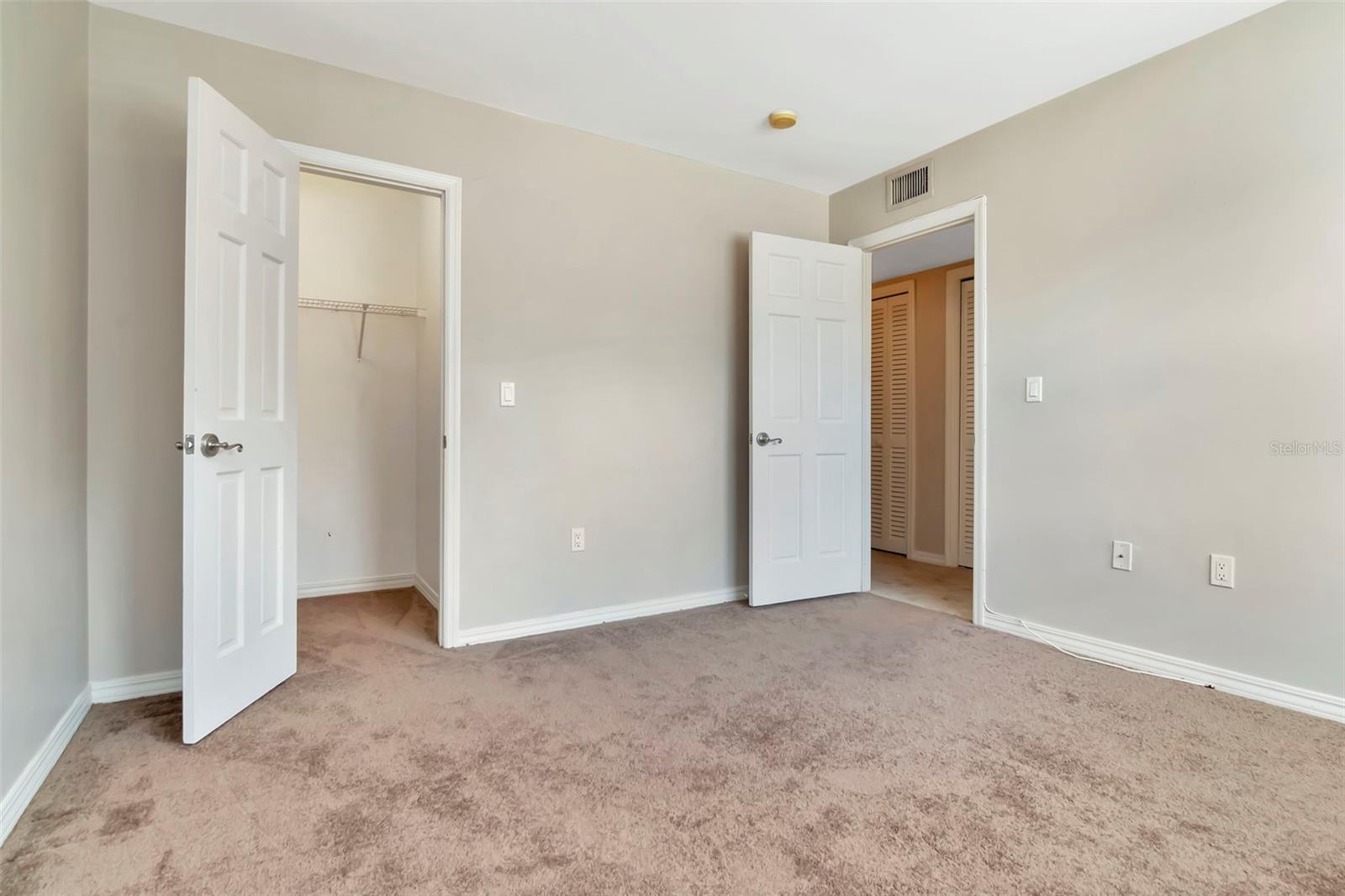 2nd bedroom with a walk in closet