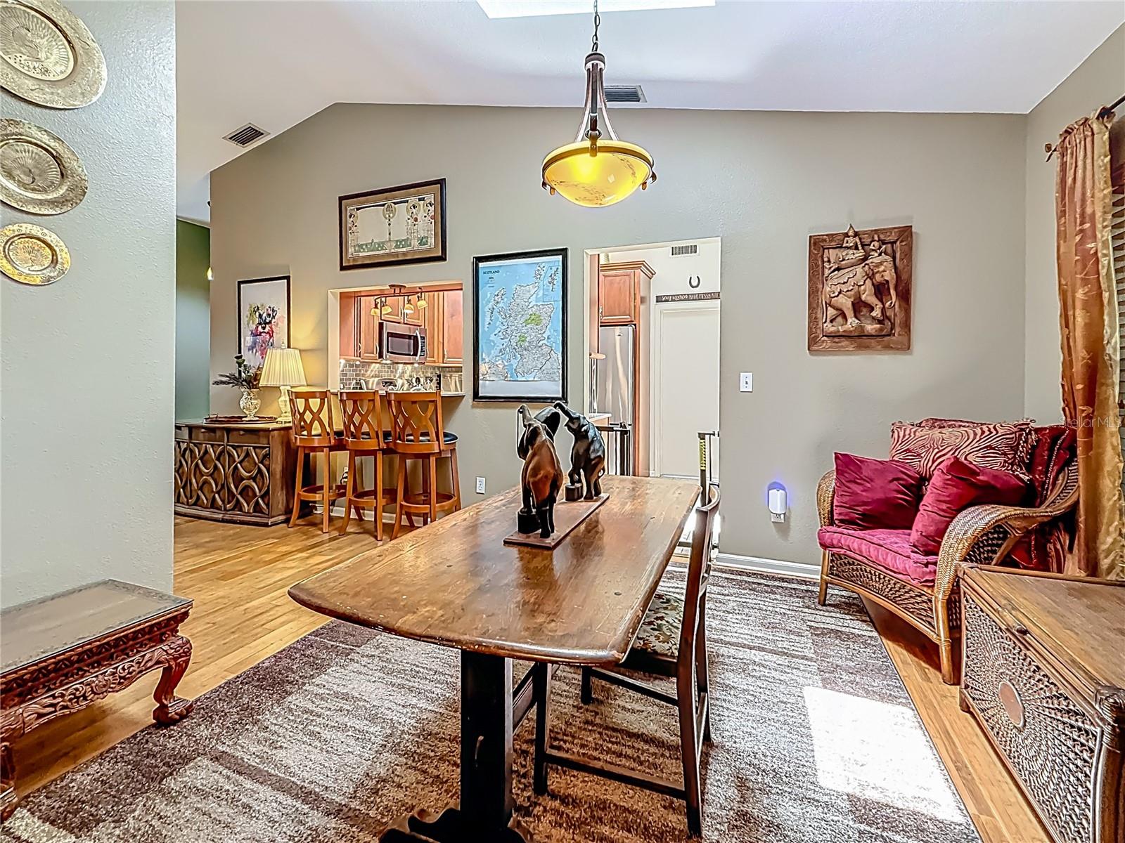 Formal dining room 11.6 x 11.9. Skylight brings in lots of natural light. Notice the vaulted ceiling? The opening leads into the updated kitchen (which includes another eating area!)
