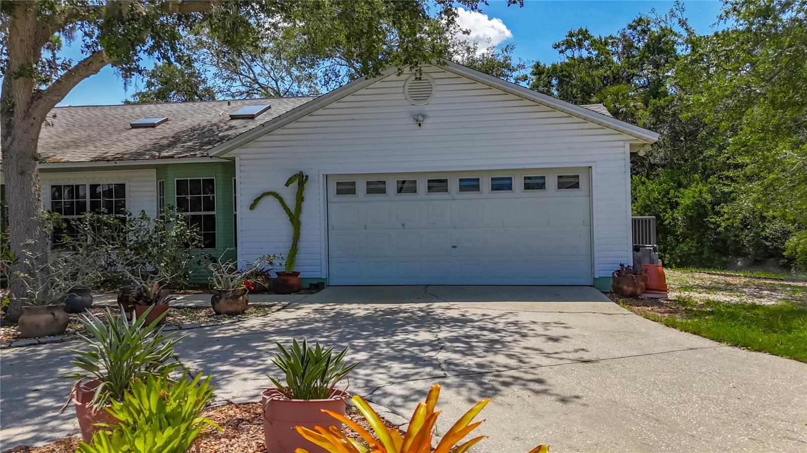 It looks like a standard 2 car garage, but inside is an extra alcove, with shelving, to accommodate additional storage & totes! YES, you are noticing 2 of the 3 skylights on the roof :-) Joe's Creek to your right.