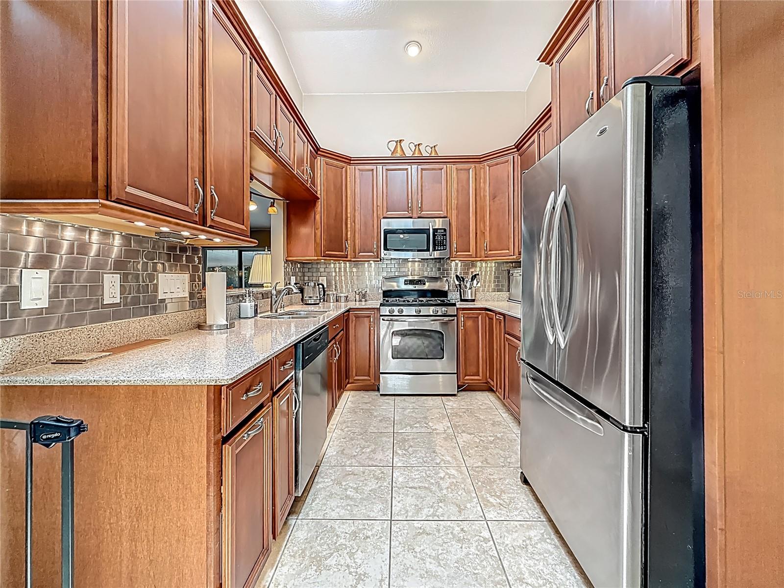 Long view of the kitchen. Measurements: 9.1 x 20.5, including the eating space behind you. The pull out trash cabinet is the first one on your left.