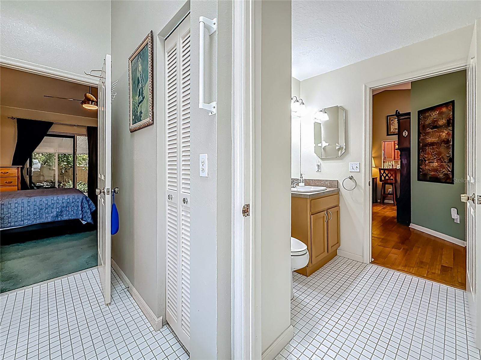 Garden tub is behind you, view into the hall bath portion of the Jack n' Jill bath, then into the foyer & living area.