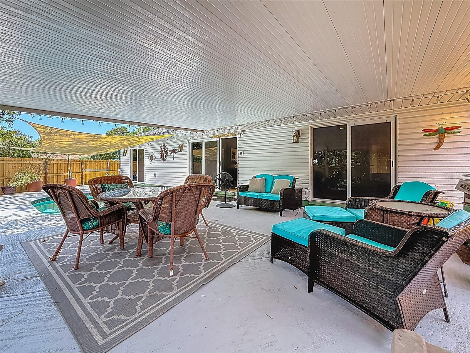 The right sliding doors are bedroom 3, the center doors are from the living room & the far left doors are from the Primary bedroom. The sail shade over the pool conveys.