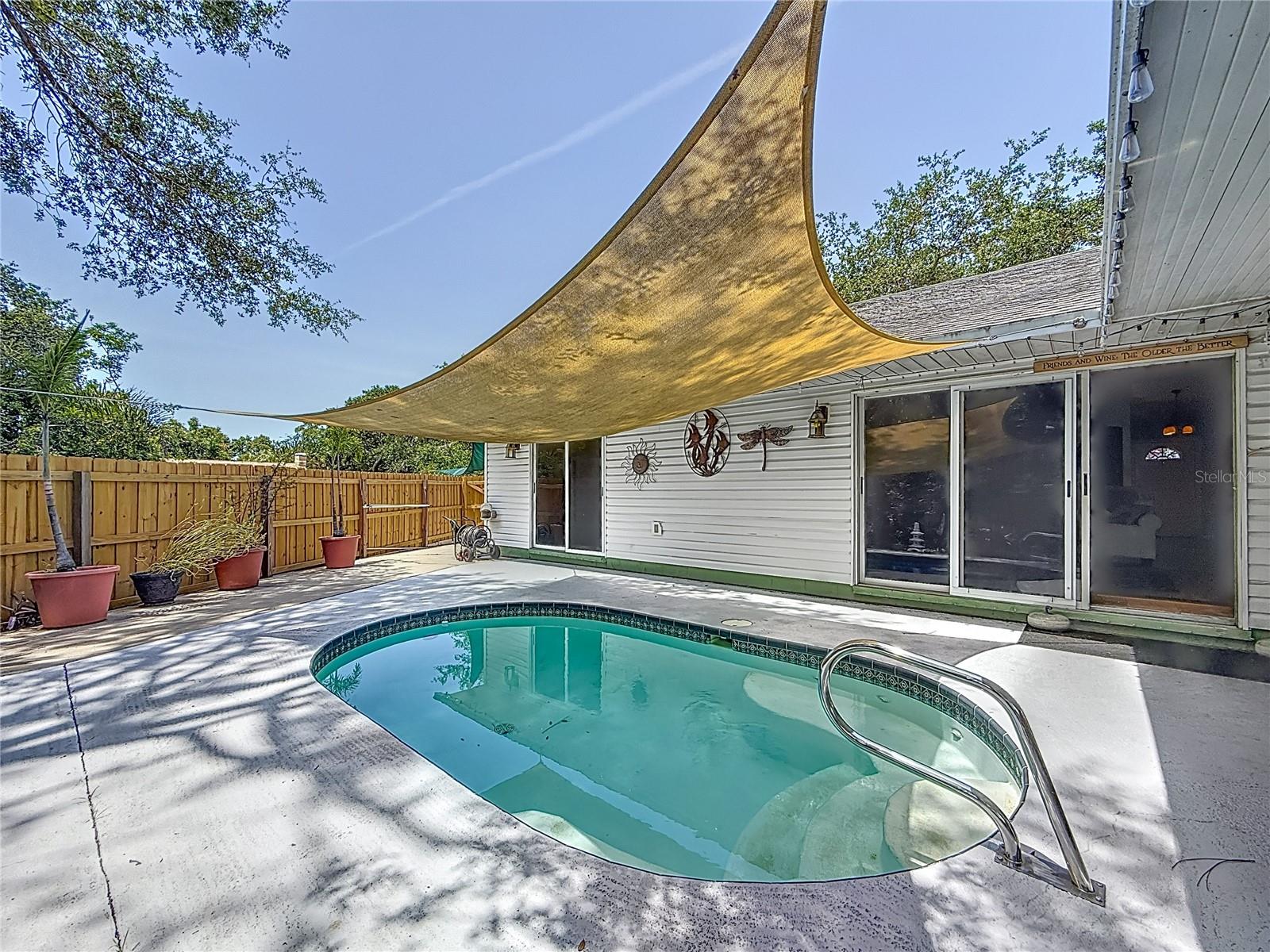 Here we have a 3600 gallon salt-water SPOOL. What is a Spool, you ask? Well, it's a cozy pool with jets at the north side. Big enough to cool of in and small enough to be easy to care for.  The sail shade DOES CONVEY.