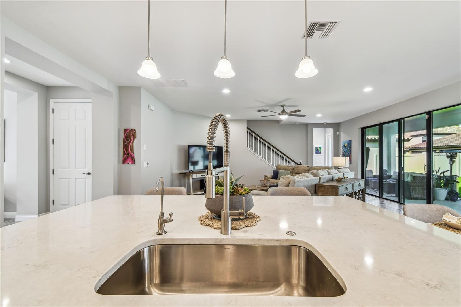 Upgraded Gourmet Kitchen w/Gas Range, SS Appliances & Hood, Built-in Oven & Microwave, Extended Cabinets, Ultra Island, Tile Backsplash, Quartz Countertops, R/O Water Filtration, Walk-in Pantry, & Plantation Shutters