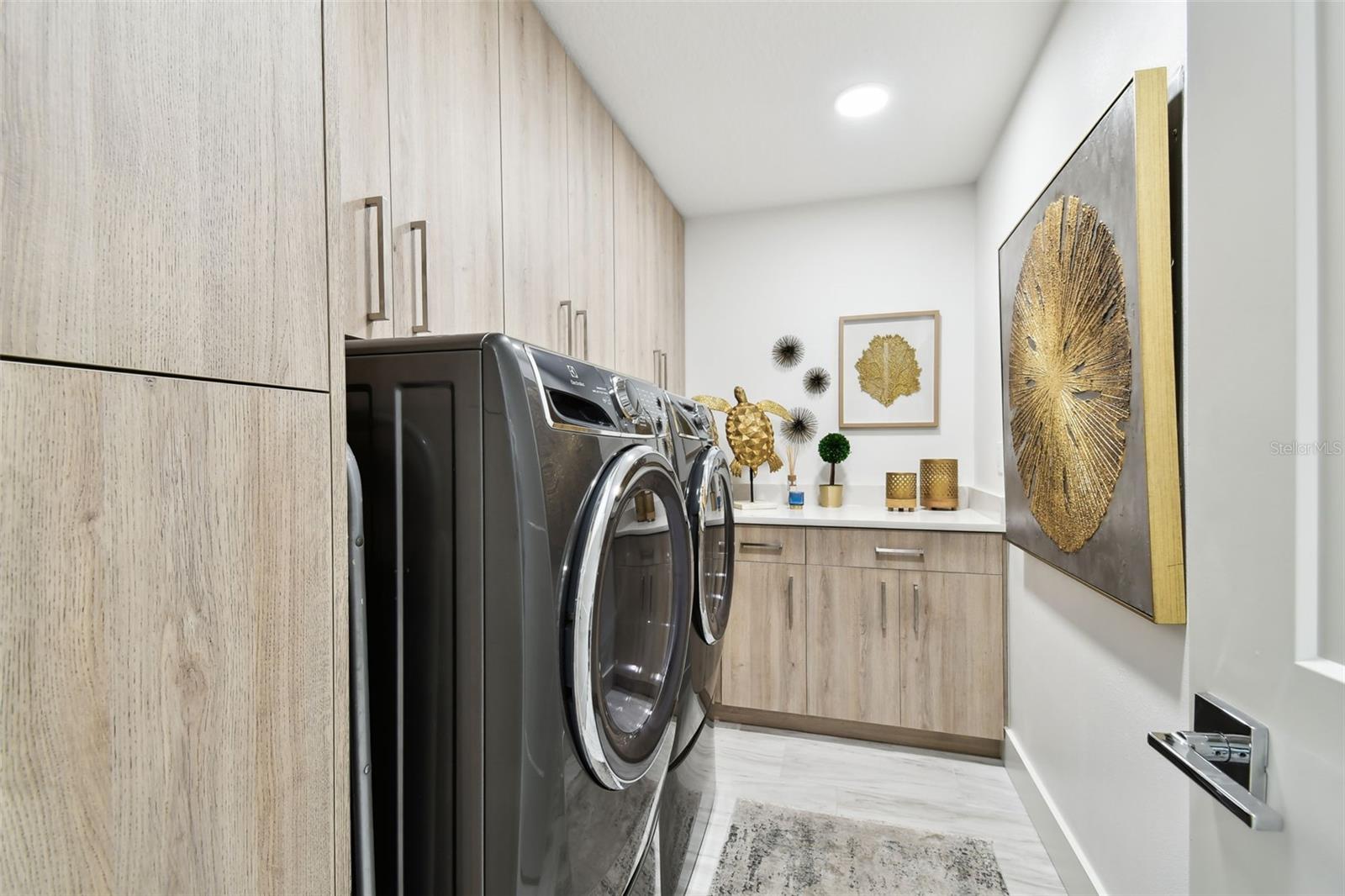 Laundry Room w/ tankless water heater & electrolux washer & dryer