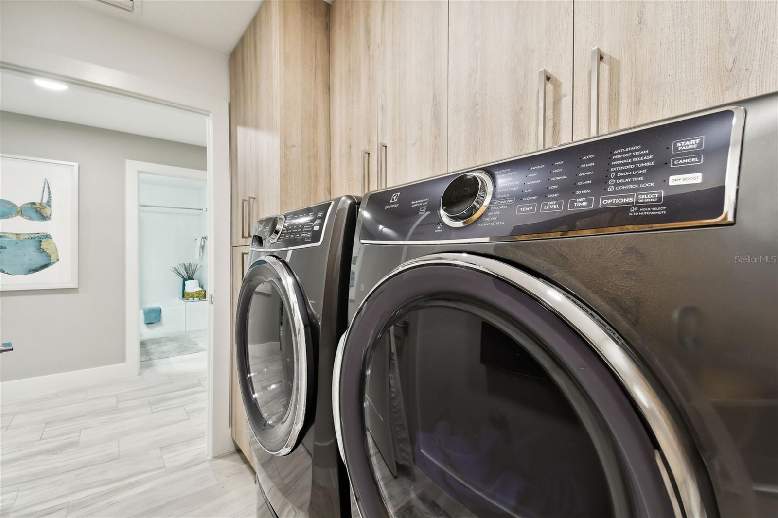 Laundry Room w/ tankless water heater & electrolux washer & dryer
