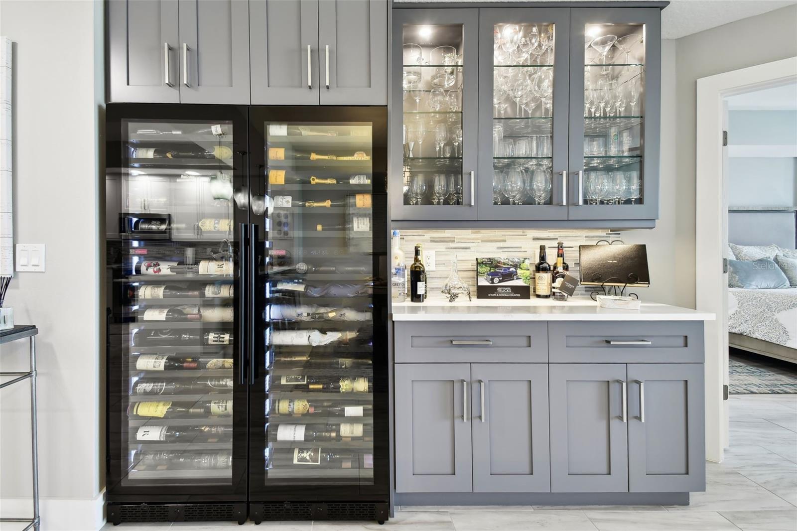 Custom Built-In Wine Bar with lit cabinets, 2 independent coolers with divided temperature zones